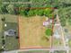 Aerial view of a spacious lot showing the single-Gathering home near a quiet country road surrounded by mature trees at 286 Bell Farm Rd, Statesville, NC 28625