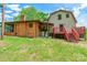 The home's brick facade and deck enhance the backyard, with ample lawn for outdoor activities at 286 Bell Farm Rd, Statesville, NC 28625