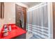 A tidy bathroom features a red countertop, wood cabinets, and shower with stylish curtain at 286 Bell Farm Rd, Statesville, NC 28625