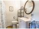 A well-lit bathroom with a classic vanity, framed mirror, toilet, and patterned shower curtain at 286 Bell Farm Rd, Statesville, NC 28625