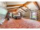 This bedroom features wood beams, hardwood floors, and multiple windows at 286 Bell Farm Rd, Statesville, NC 28625