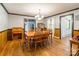 Classic dining room featuring hardwood floors, wood paneling and warm lighting at 286 Bell Farm Rd, Statesville, NC 28625