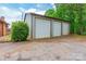 Three car garage with a concrete driveway and mature landscaping at 286 Bell Farm Rd, Statesville, NC 28625