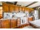 The kitchen features wood cabinets, a white oven over brick, and stainless steel appliances at 286 Bell Farm Rd, Statesville, NC 28625