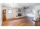 Bright living room with hardwood floors, brick fireplace, ceiling fan, and natural light at 286 Bell Farm Rd, Statesville, NC 28625