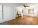 Bright living room with original hardwood floors, vintage ceiling fan, and neutral paint at 286 Bell Farm Rd, Statesville, NC 28625