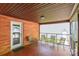 Cozy covered patio with a brick accent wall, furniture, and a door leading to the exterior at 286 Bell Farm Rd, Statesville, NC 28625