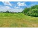 Sprawling yard with lush greenery and mature trees, ideal for outdoor activities at 286 Bell Farm Rd, Statesville, NC 28625