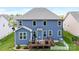 Back exterior of home featuring a deck, and large backyard with fresh green grass at 2936 Shumard Dr, Gastonia, NC 28054