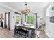 Inviting dining room features stylish light fixture, hardwood floors, and a bench adding a touch of modern elegance at 2936 Shumard Dr, Gastonia, NC 28054