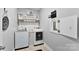 Efficient laundry room with modern appliances, organized shelving, and a convenient folding area, maximizing functionality at 2936 Shumard Dr, Gastonia, NC 28054