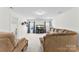 Bright living room with a large TV, a cozy sectional sofa, and windows with charming curtains at 2936 Shumard Dr, Gastonia, NC 28054