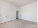 Bright bedroom featuring plush carpeting and a closet with double doors at 3007 West Blvd, Charlotte, NC 28208