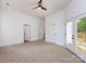 Spacious bedroom features a ceiling fan, carpeted floors, and three doors at 3007 West Blvd, Charlotte, NC 28208