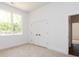 Bright bedroom with large window, double closet, and neutral carpeting at 3007 West Blvd, Charlotte, NC 28208