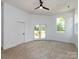 Spacious bedroom with a ceiling fan, carpeted floors, and glass doors to deck at 3007 West Blvd, Charlotte, NC 28208