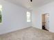 This bedroom has carpet floors, white walls, and a doorway to an ensuite bathroom at 3007 West Blvd, Charlotte, NC 28208