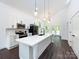 Well-lit kitchen featuring white cabinetry, stainless steel appliances, and a large island at 3007 West Blvd, Charlotte, NC 28208