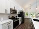 Elegant kitchen featuring stainless steel appliances, a subway tile backsplash, and dark fixtures at 3007 West Blvd, Charlotte, NC 28208