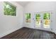 Bright living room features wood floors, large windows, and glass doors to a deck at 3007 West Blvd, Charlotte, NC 28208