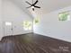 Open living room with high ceilings, lots of natural light, and sleek ceiling fan at 3007 West Blvd, Charlotte, NC 28208