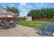 Fenced backyard with patio, outdoor dining set, shed, and lush green lawn at 314 Pulaski Sw Dr, Concord, NC 28027