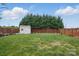 Backyard featuring a well-maintained lawn, a shed, and a decorative wooden fence at 314 Pulaski Sw Dr, Concord, NC 28027