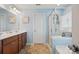A bright bathroom features a double vanity, walk-in shower, and a separate soaking tub at 314 Pulaski Sw Dr, Concord, NC 28027