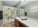 Bathroom features a single sink, patterned shower curtain, and decorative wall art at 314 Pulaski Sw Dr, Concord, NC 28027