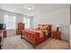 A neutral-toned bedroom provides a relaxing space, and is filled with natural light from two windows at 314 Pulaski Sw Dr, Concord, NC 28027