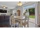 Dining area adjacent to the kitchen with a view of the living room and sliding glass doors to the backyard at 314 Pulaski Sw Dr, Concord, NC 28027