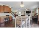 Dining area adjacent to the kitchen with a desk, staircase, view of the living room and hardwood floors at 314 Pulaski Sw Dr, Concord, NC 28027