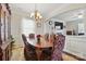 View of an elegant dining room with hardwood floors and bright light fixture at 314 Pulaski Sw Dr, Concord, NC 28027