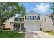 Two-story home with a front porch, two-car garage and a mix of brick, siding, and stone exterior finishes at 314 Pulaski Sw Dr, Concord, NC 28027