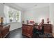 Bright office with dark hardwood floors, white trim, and a large window providing natural light at 314 Pulaski Sw Dr, Concord, NC 28027