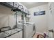 The laundry room is equipped with a washer, dryer, hanging rack, and plenty of storage at 314 Pulaski Sw Dr, Concord, NC 28027