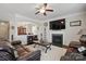 Comfortable living room with a fireplace, leather furniture, ceiling fan and view of dining room at 314 Pulaski Sw Dr, Concord, NC 28027