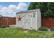 Backyard shed with decorative star and secure double doors for storage at 314 Pulaski Sw Dr, Concord, NC 28027