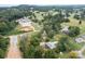 This aerial perspective highlights the house, a long driveway, a grassy yard, and many trees at 3430 Stokes Ferry Rd, Salisbury, NC 28146
