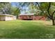 Expansive backyard featuring a brick house, shed, and mature trees, ideal for outdoor living at 3430 Stokes Ferry Rd, Salisbury, NC 28146