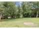 Large, green backyard bordered by mature trees offering shade and privacy at 3430 Stokes Ferry Rd, Salisbury, NC 28146