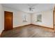 Well-lit bedroom with wood-look flooring and two windows at 3430 Stokes Ferry Rd, Salisbury, NC 28146