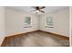 Bright bedroom with hardwood floors, ceiling fan, and two windows offering natural light at 3430 Stokes Ferry Rd, Salisbury, NC 28146