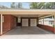 View of the spacious carport featuring a double garage door and brick exterior at 3430 Stokes Ferry Rd, Salisbury, NC 28146