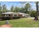 Single-story red brick home featuring a carport, mature trees, and a well-kept lawn at 3430 Stokes Ferry Rd, Salisbury, NC 28146