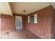 Close-up side view of a brick home's covered patio and entry door at 3430 Stokes Ferry Rd, Salisbury, NC 28146