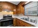 Kitchen with wood cabinets, updated appliances, and solid surface countertops at 3430 Stokes Ferry Rd, Salisbury, NC 28146