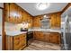 Kitchen showcasing wood cabinets, solid surface countertops, and wood-look vinyl flooring at 3430 Stokes Ferry Rd, Salisbury, NC 28146