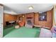 Cozy living room with brick fireplace, wood paneling, and multiple windows at 3430 Stokes Ferry Rd, Salisbury, NC 28146