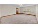 Bright living room featuring neutral carpet, wood trim, and natural light from the window at 3430 Stokes Ferry Rd, Salisbury, NC 28146
